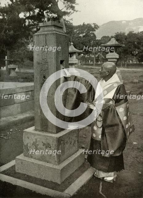 'A Buddhist Priest and Praying-Wheel', 1910. Creator: Herbert Ponting.