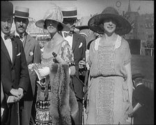 Civilians Wearing Smart Outfits and Hats Posing for the Camera During a Horse Race, 1920. Creator: British Pathe Ltd.