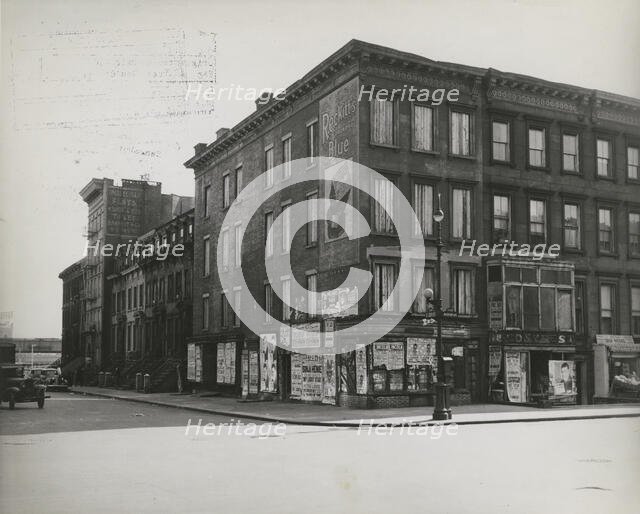 Boarded residential building on the corner of Madison Avenue and East 133rd Street..., 1938. Creator: Aubrey Pollard.