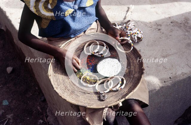 Girl selling hand-made bracelets, Mali, 1990. Creator: Amanda Waite.
