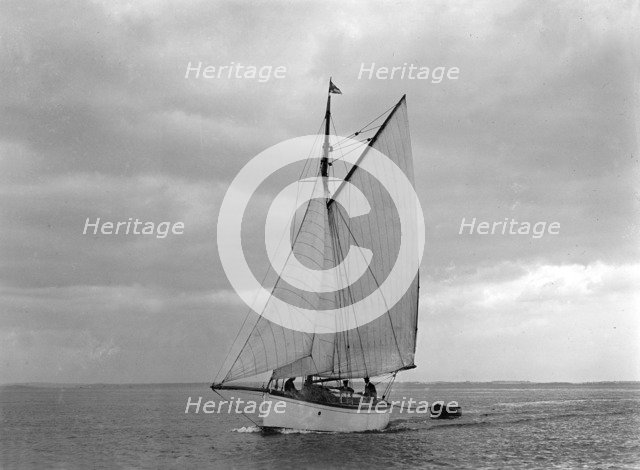 The gaff rig sailboat 'Bunty' close-hauled, 1921. Creator: Kirk & Sons of Cowes.