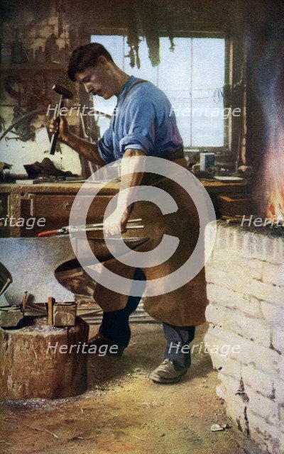 Blacksmith at work, England, c1922. Artist: Sidney H Nicholls