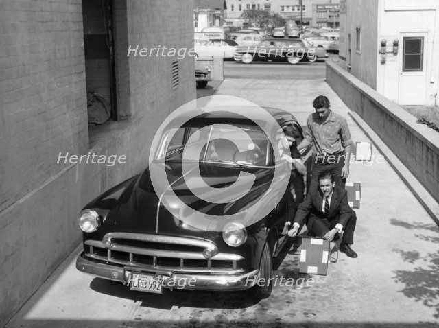 Men with a 1949 customised Chevrolet, (c1949?). Artist: Unknown