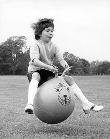 Girl on a space hopper, 1970s.