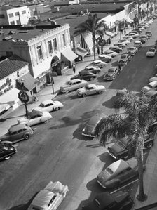 Street scene with cars parked, USA, c1952. Artist: Unknown