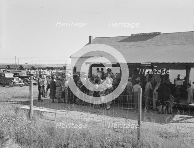 Farmers come to town on Saturday afternoon for auction sale...back street in Nyssa, Oregon, 1939. Creator: Dorothea Lange.