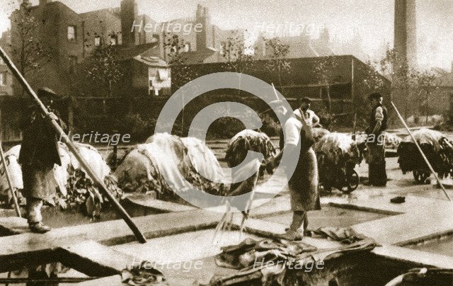 Making leather in the lime yard at Neckinger Mills, London, 20th century. Artist: Unknown