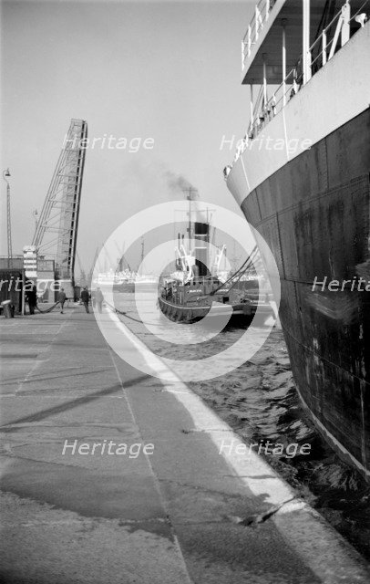A ship being towed into the King George V Dock, Canning Town, London, c1945-c1965.  Artist: SW Rawlings