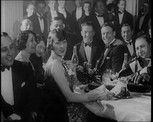 A Group of Fashionable Young People Sitting at a Table Drinking Champagne, 1924. Creator: British Pathe Ltd.