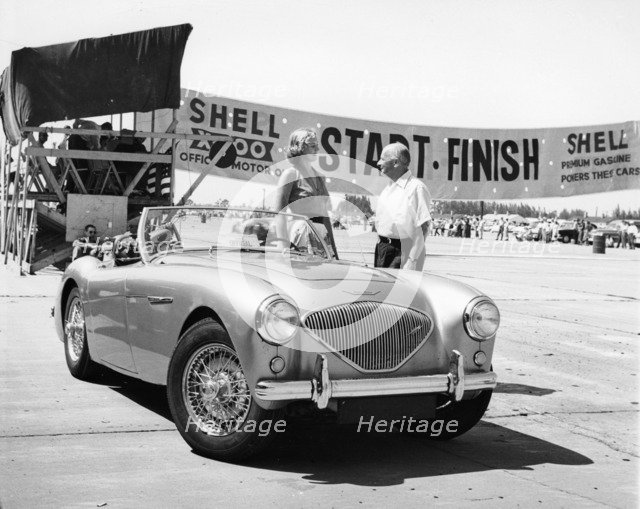 Donald Healey with an Austin Healey at a motor race. Artist: Unknown
