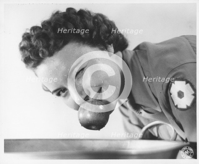 Woman soldier bobbing for apples, Fort Sheridan, Illinois, USA, 1943. Artist: US Army