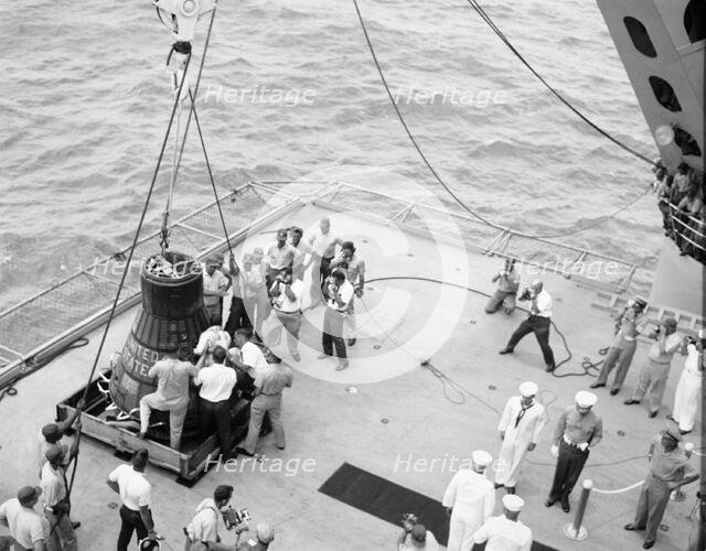Gordon Cooper and capsule on deck, Pacific Ocean, 1963.  Creator: NASA.
