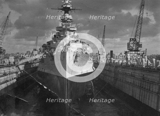 British battleship HMS 'Malaya' in a floating dock, Malta, c1937. Artist: Unknown