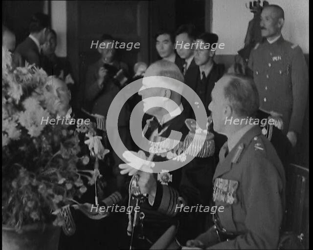 British and Japanese Military Leaders Sitting and Standing Around a Table, 1937. Creator: British Pathe Ltd.