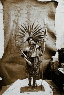 A man of an Amazonian tribe, holding a spear and wearing a feathered head-dress, in a..., 1900. Creator: Marc Ferrez.