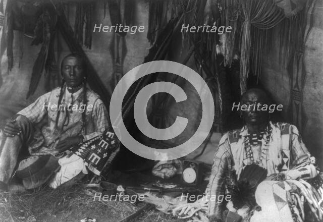 In a Piegan lodge, c1910. Creator: Edward Sheriff Curtis.