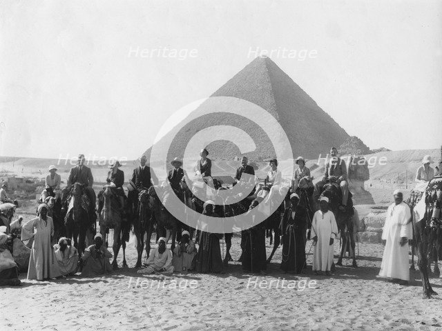 Camel tour in front of one of the Pyramids of Giza, Egypt, c1920s-c1930s(?). Artist: Unknown