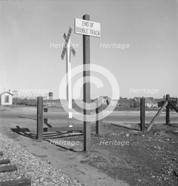 Migrants' tents...along the right of way of the southern pacific, near Fresno, California, 1939. Creator: Dorothea Lange.