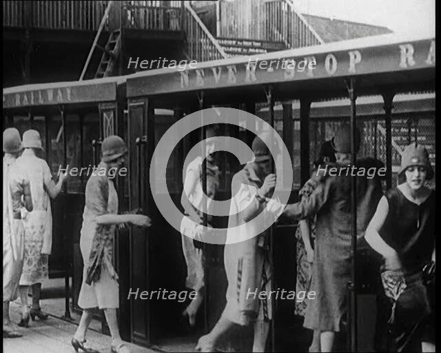 A Group of Female Civilians Board a Carriage of the 'Never Stop Railway', 1924. Creator: British Pathe Ltd.
