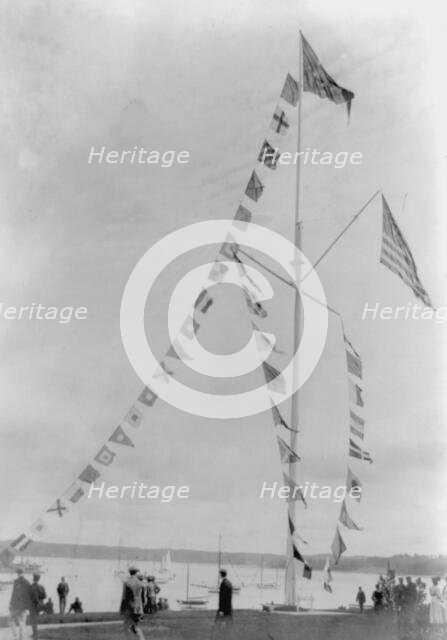 Pole with flags of different countries; sailboats in background, Oyster Bay, Long Island, N.Y., 1905 Creator: Frances Benjamin Johnston.