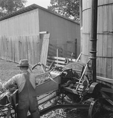 Farmers feeding corn into cooperatively..., near W Street at Carlton, Yamhill County, Oregon, 1939. Creator: Dorothea Lange.
