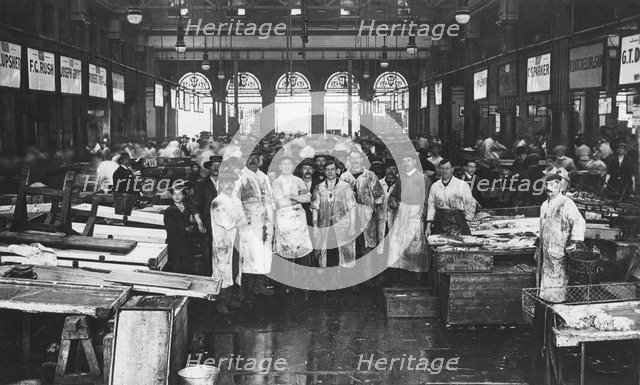 The interior of Billingsgate Market showing fishmongers and their stalls, London, c1918. Artist: Unknown