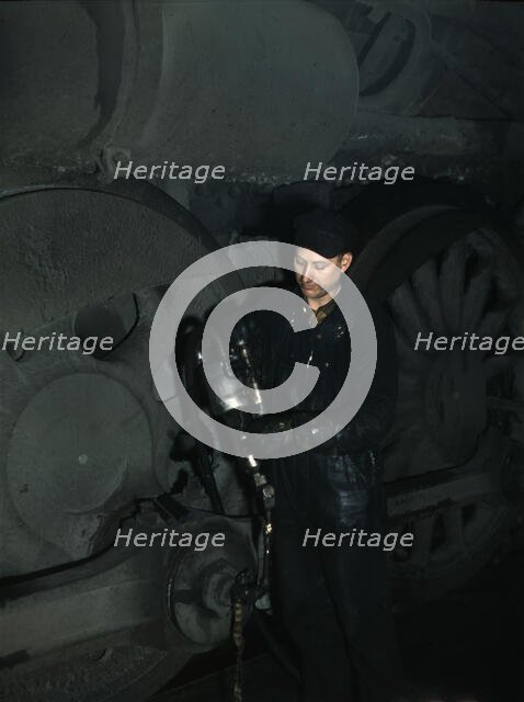 Greasing a locomotive in the roundhouse at Proviso (?) yard, C & NW RR, Chicago, Ill., 1942. Creator: Jack Delano.