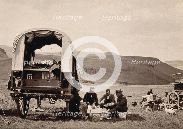 South Africa: a group of Europeans eating a meal beside their wagon in the Transvaal, c1890s. Creator: Dudley Kidd.