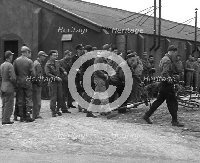 American Airmen Queueing up Outside a Building at an Airfield in England, 1943-1944. Creator: British Pathe Ltd.
