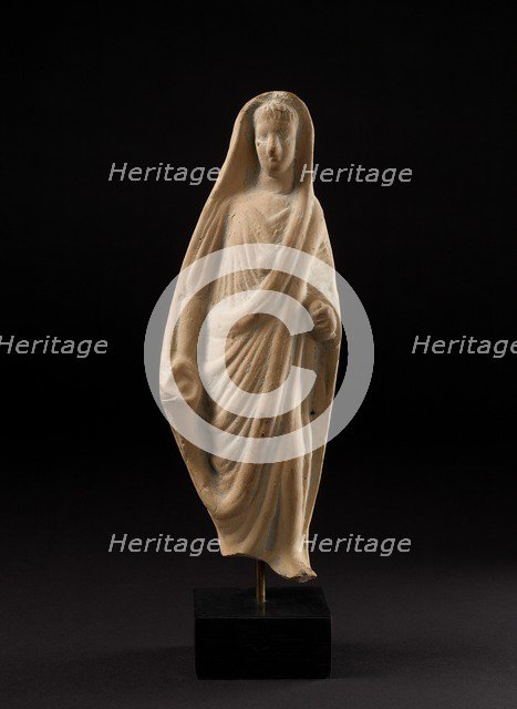 Terracotta statuette of a pious Roman veiling his head with his toga, 1st century. Artist: Unknown.