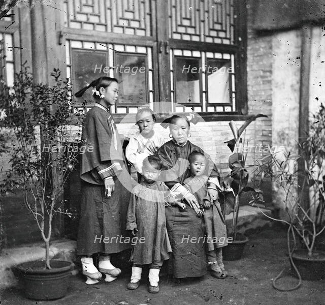 China: a Manchu lady with her daughter in-law and grandchildren, Beijing, 1869. Creator: John Thomson.