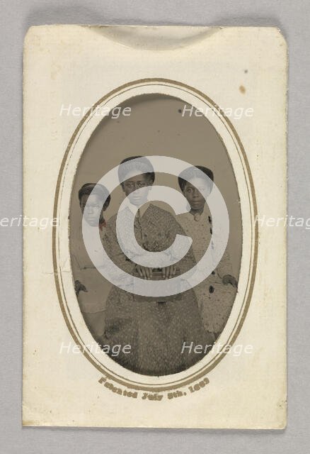 Tintype in a paper case of three unidentified young women seated, 1870s. Creator: Unknown.