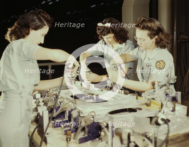 Drilling a wing bulkhead for a transport plane at the Consolidated Air..., Fort Worth, Texas, 1942. Creator: Howard Hollem.