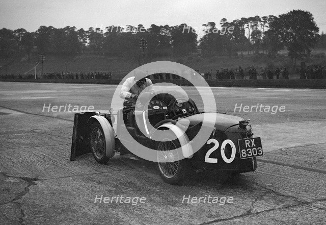 Mechanic making adjustments to a MG C type, Brooklands. Artist: Bill Brunell.