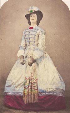 A man in drag wearing an elaborate dress and feathered hat, (20th century?). Creator: Unknown.