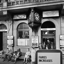 Passengers waiting outside the ticket office, Charing Cross Station, London, 1970. Artist: John Gay