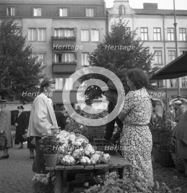 Fruit and vegetable stall selling cauliflowers in the market, Malmö, Sweden, 1947. Artist: Otto Ohm