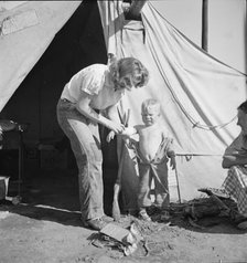 In a carrot pullers' camp near Holtville, California, 1939. Creator: Dorothea Lange.