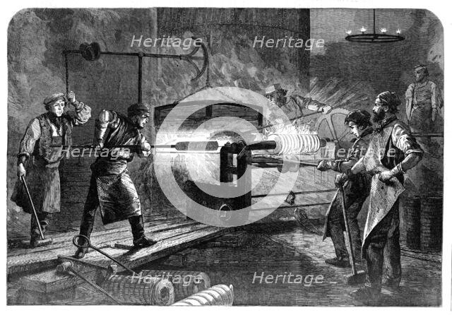Manufacture of the Armstrong Gun at Woolwich Arsenal: coiling the bars, 1862. Creator: Unknown.
