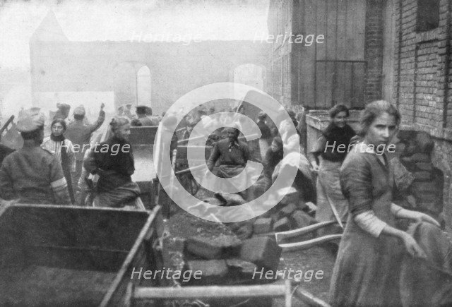 The inhabitants of Caudry come to seek food from the British Army, France, 1918. Artist: Unknown