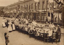 ' A children's tea party in an East End Street in London, to celebrate the Treaty of Versailles at t Artist: Unknown.