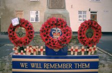 Poppy wreaths on a war memorial, West Yorkshire.  Artist: Dorothy Burrows