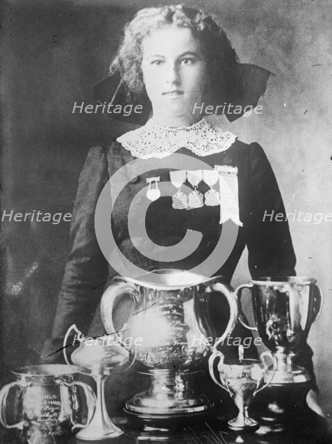 Alsie Aykroyd in front of her trophies, 1910. Creator: Bain News Service.