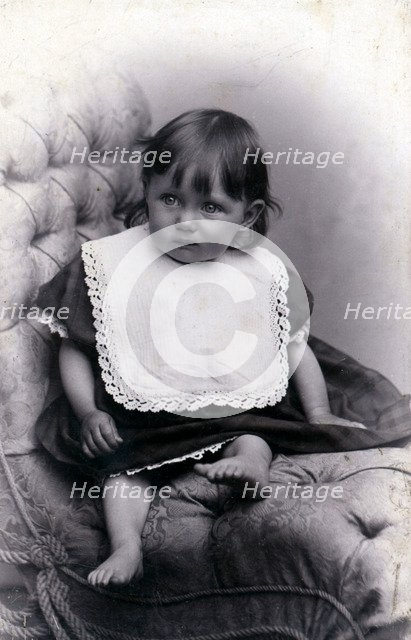 Portrait of a little girl in a big chair, c1910. Artist: Unknown