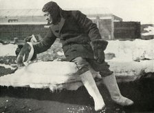 'Lieut. Rennick and a Friendly Penguin', 1911, (1913). Artist: Herbert Ponting.