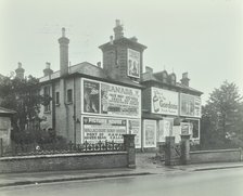Advertising hoardings on the wall of a building, Wandsworth, London, 1938. Artist: Unknown.