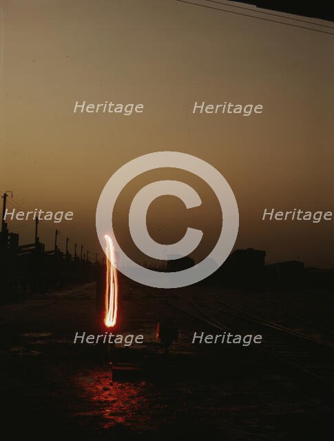 Indiana Harbor Belt RR, switchman demonstrating signal with a "fusee"..., 1943. Creator: Jack Delano.