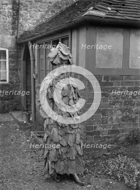 A woman in a cabbage leaf costume, Hellidon, Northamptonshire, c1896-c1920. Artist: A Newton
