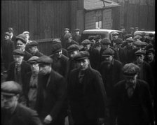 Crowd of Men Walking Through the Street Towards the Camera, 1933. Creator: British Pathe Ltd.