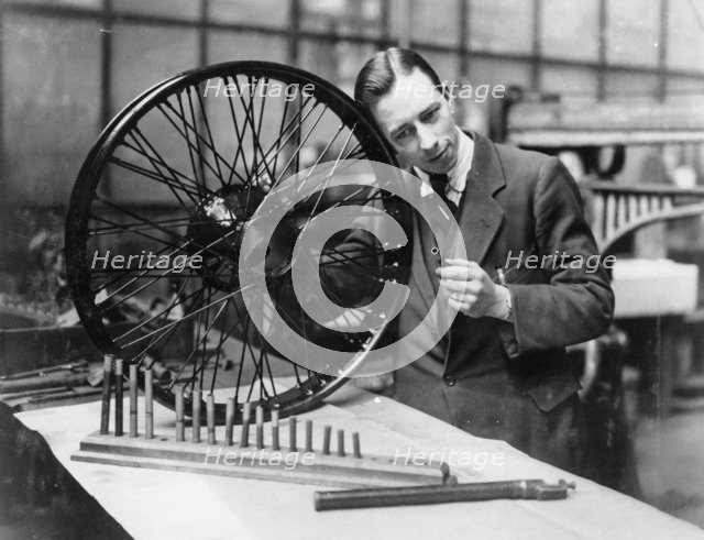 A man in a workshop with a wheel. Artist: Unknown